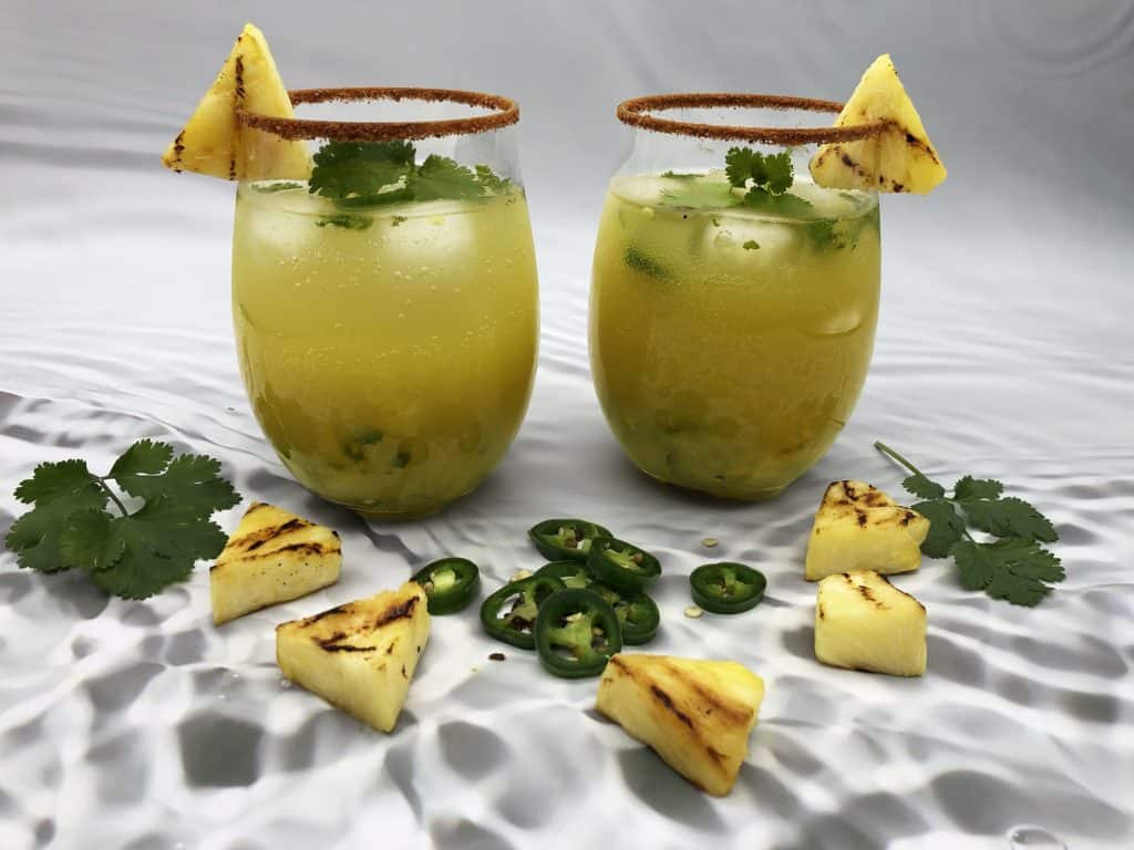 Two glasses of virgin spicy pineapple mojito mocktails ready to drink