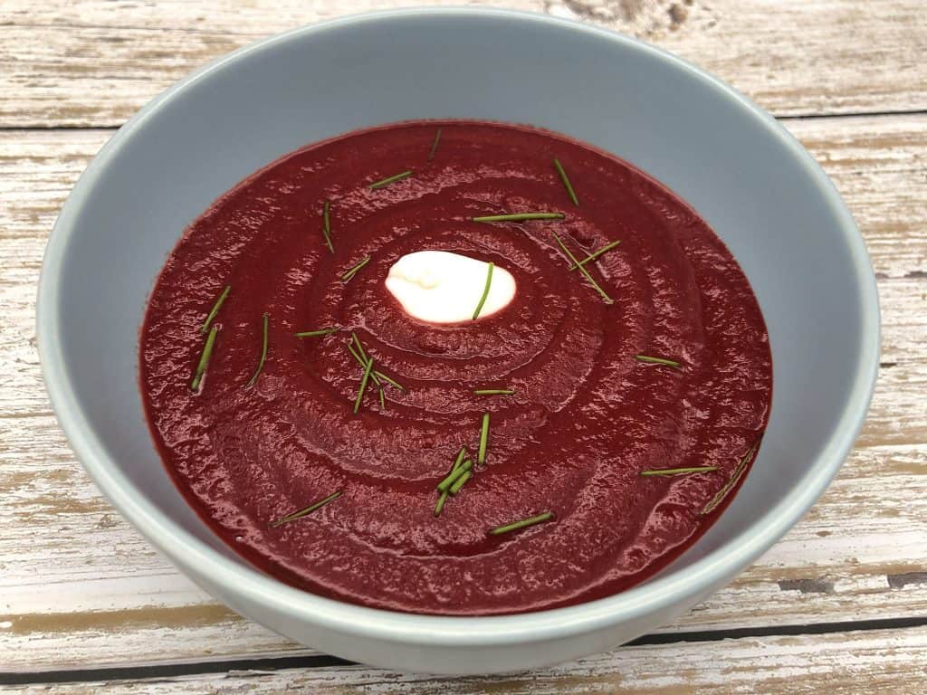 A bowl of homemade beetroot soup with chives and crème fraiche
