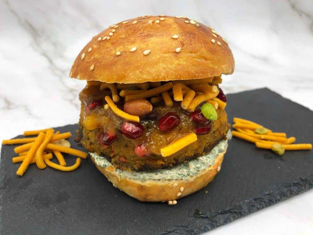 Spicy potato burger on a slate ready to eat