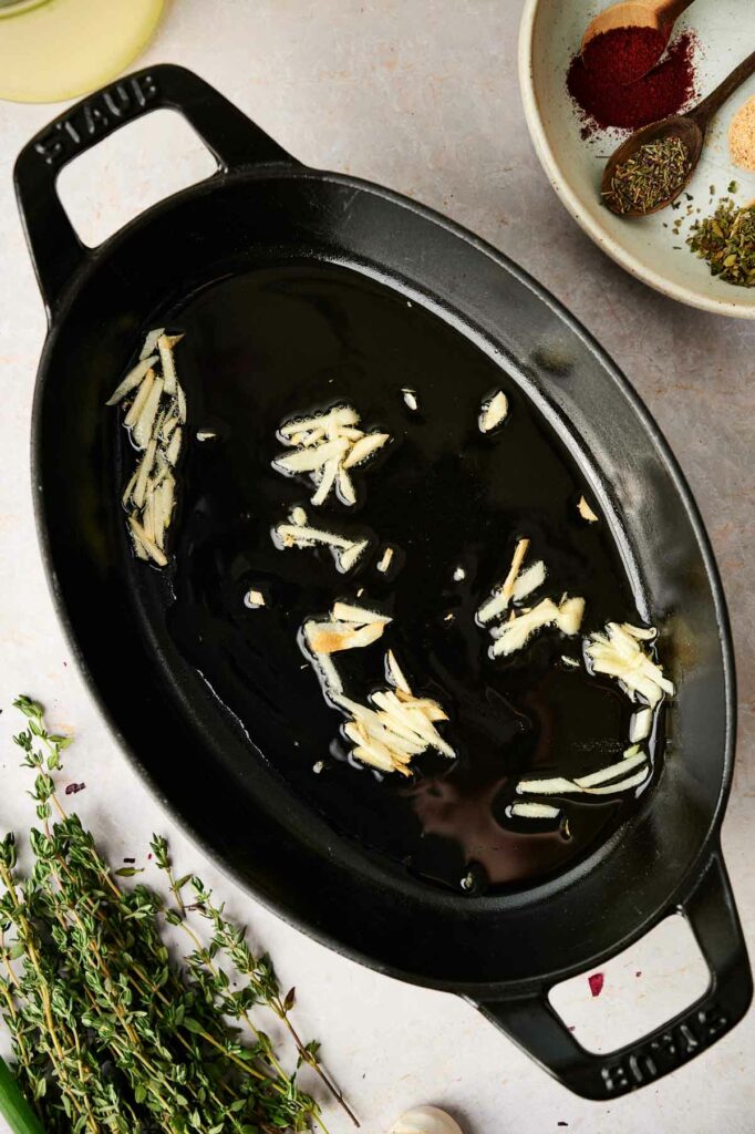 A cast iron skillet with garlic.