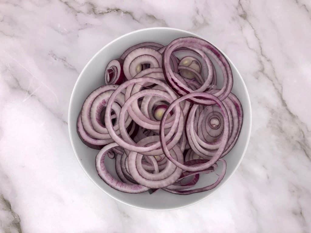 Sliced red onions in a bowl
