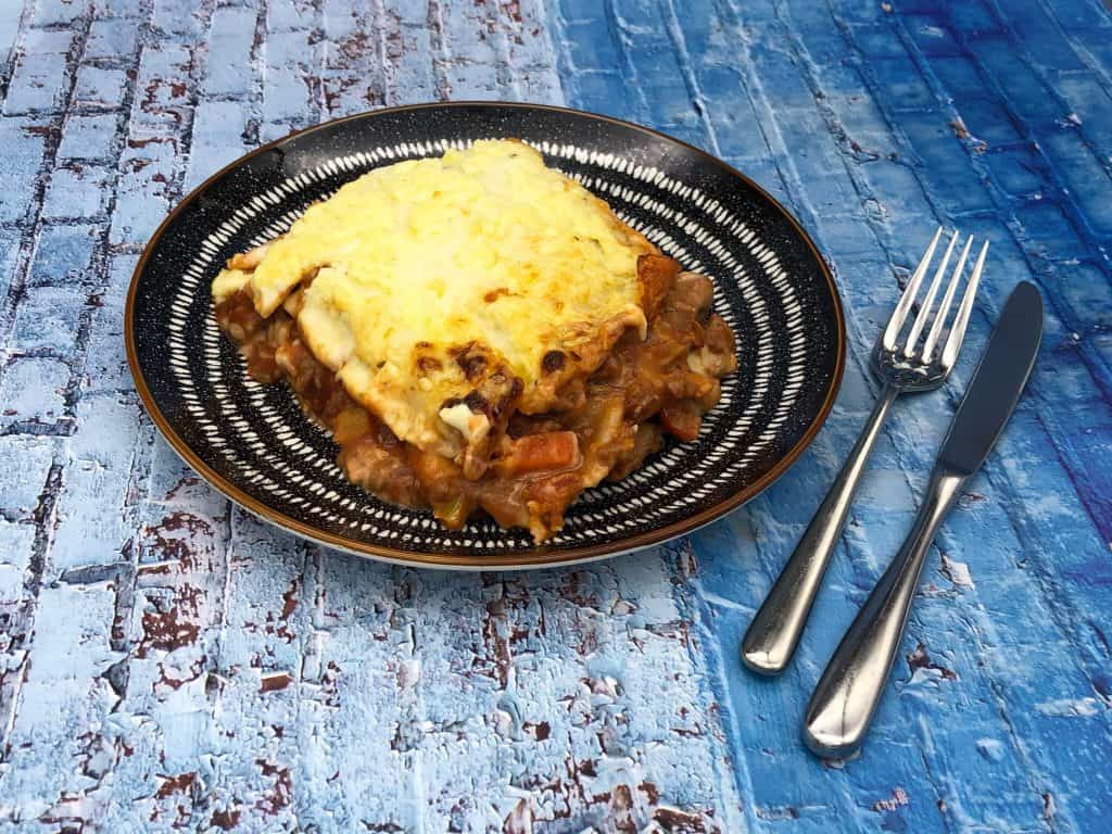 Vegetarian lasagna ready to eat with knife and fork