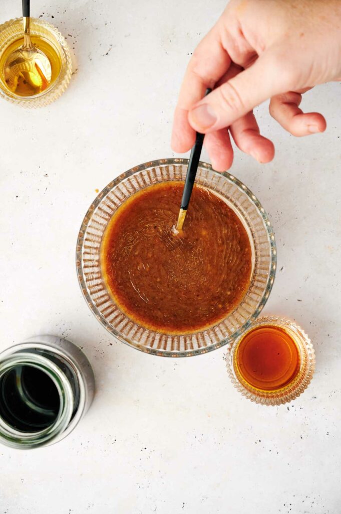 A person is stirring the stir fry sauce