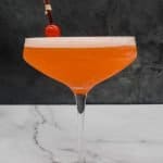 Beautiful orange Aperol sour cocktail in a glass