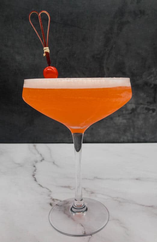 Beautiful orange Aperol sour cocktail in a glass
