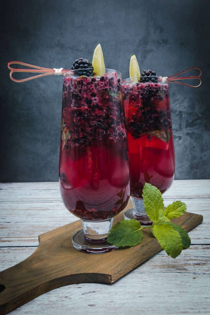 Two blackberry mojitos with fresh mint