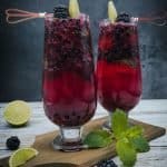 Blackberry mojito cocktails on a wooden board