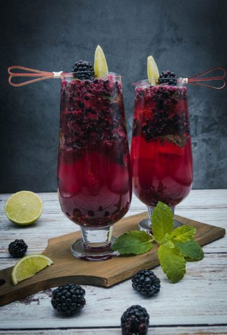 Blackberry mojito cocktails on a wooden board