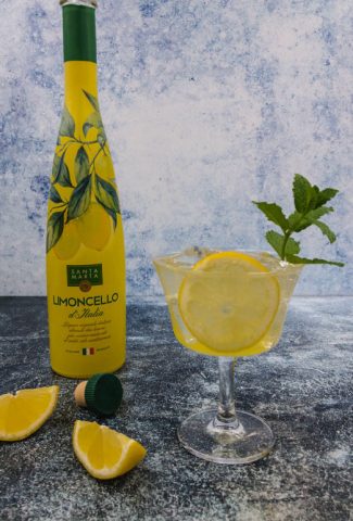 Limoncello spritz cocktail ready to drink with mint, ice and slice of lemon