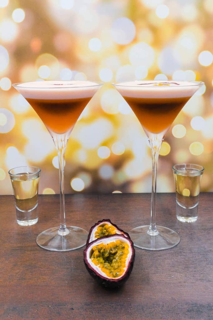 Two stunning porn star martini cocktails with zero alcohol, alcohol free champagne substitute and fresh passion fruits