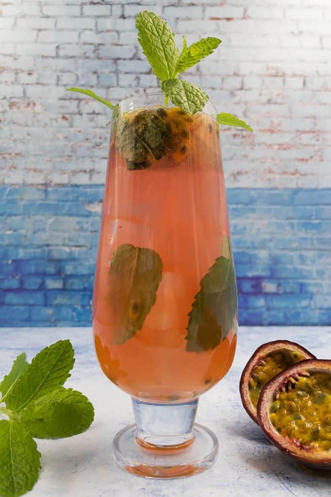 Refreshing homemade passion fruit mojito with mint leaves and passion fruit