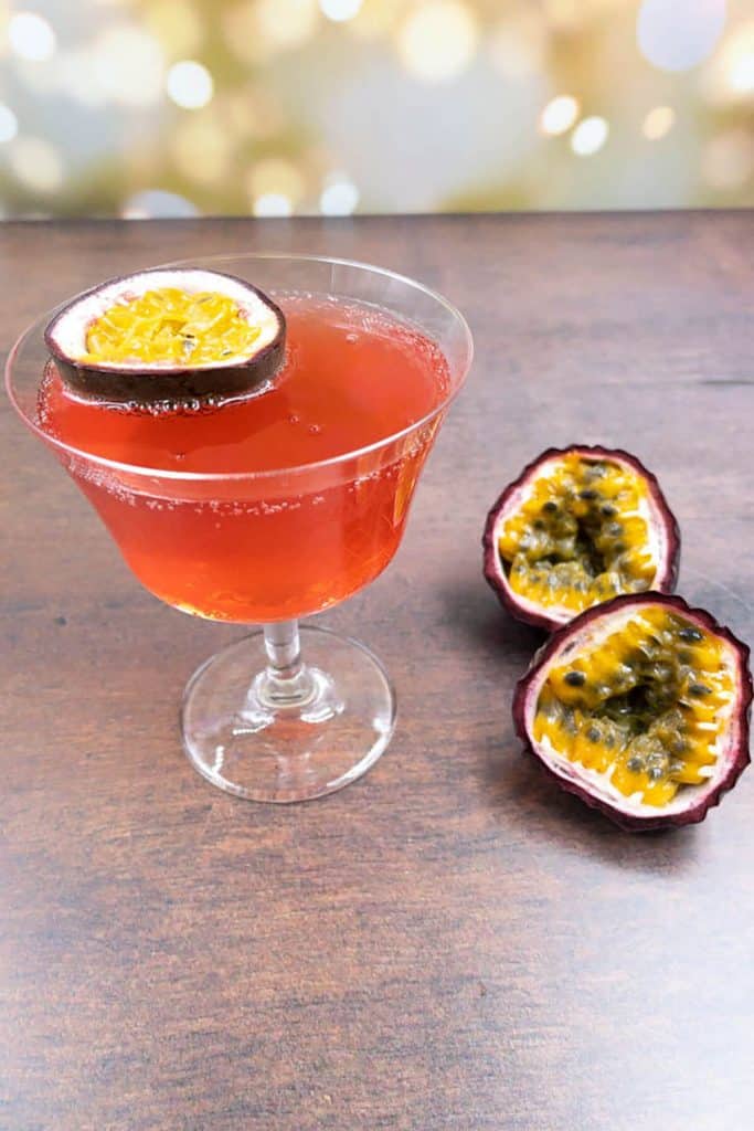 A chilled passion fruit spritz with a passion fruit garnish