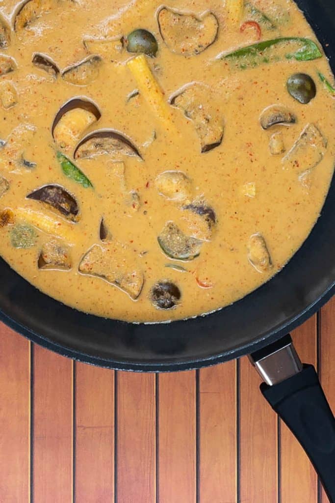 Curry vegan Thai red made with canned coconut milk with baby corn, eggplant, mangetout and mushrooms, delicious and ready to eat 