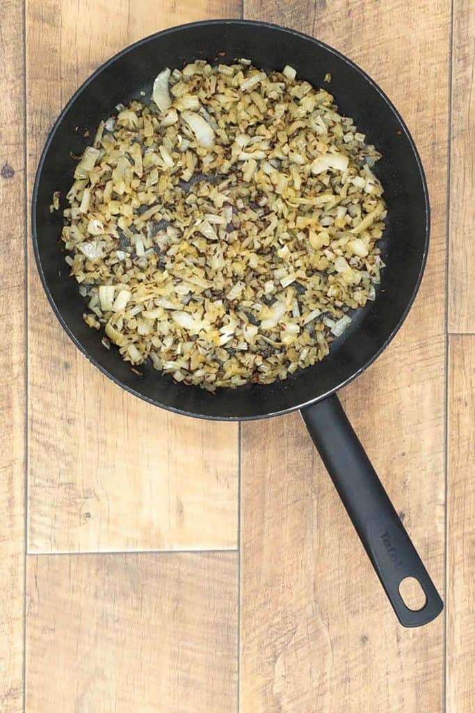 Onion, ginger, garlic and cumin seeds in a pan