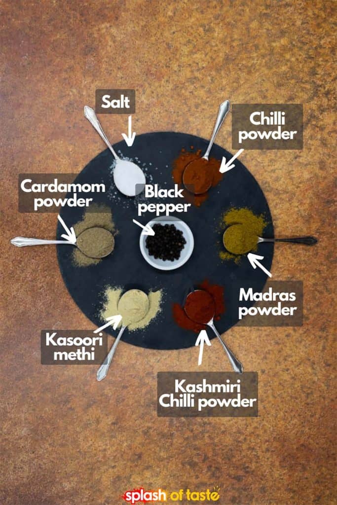 Spices for vegan vegetable vindaloo, salt, chilli powder, black pepper, madras powder, kashmiri chilli powder, kasoori methi and cardamom powder