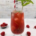 Delicious raspberry mojito cocktail with mint garnish.