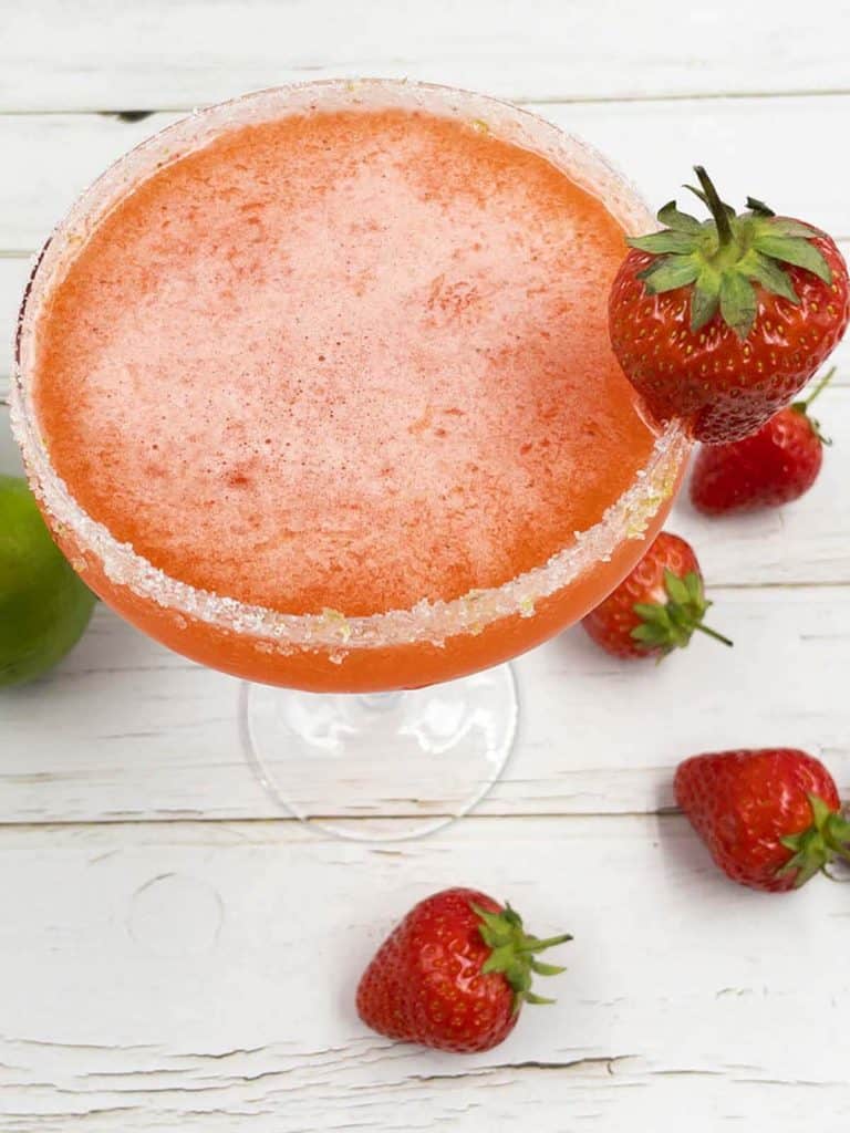 Delicious homemade strawberry daiquiri drink with a lime sugar rim.