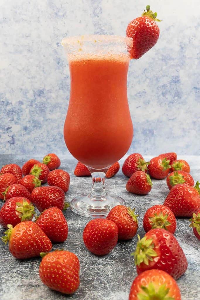 Refreshing fun strawberry daiquiri mocktail drink with a lime sugar rim and strawberry garnish.