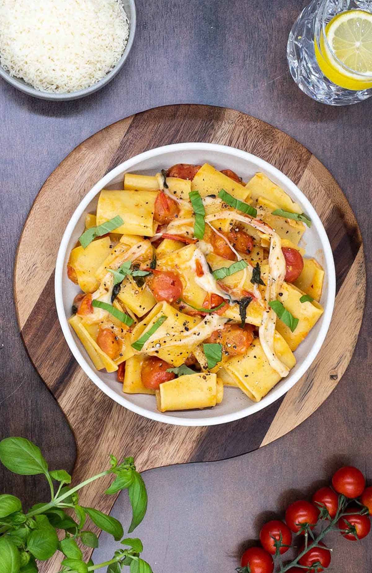 A homemade bowl of pasta alla sorrentina on a board.
