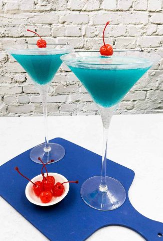 Two Envy cocktails with maraschino cherries.