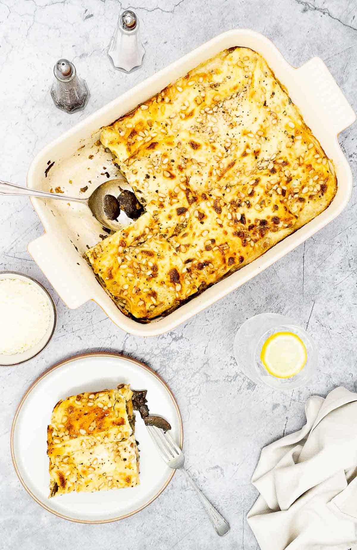 Homemade lasagne al forno in a baking dish and on a plate.