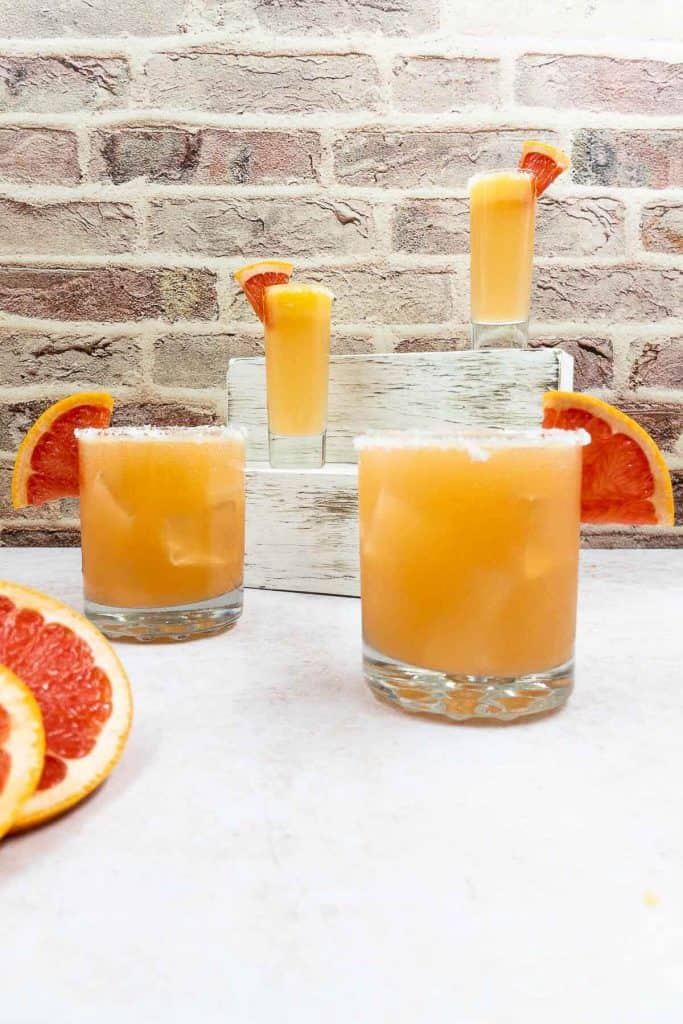 Paloma cocktails, with salt rims and grapefruit slices.
