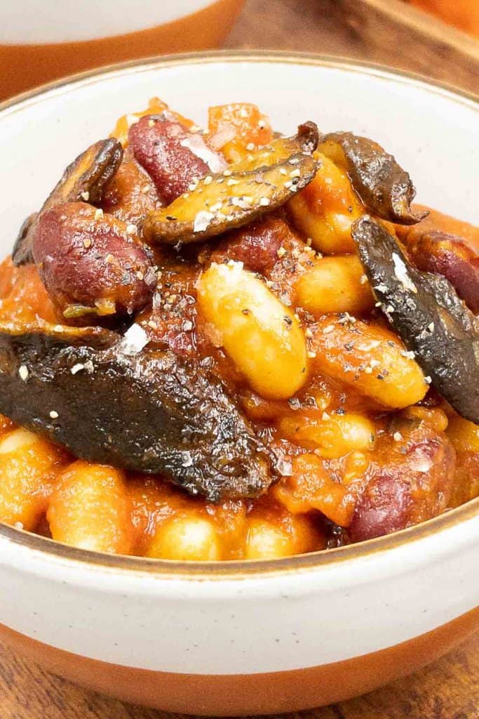 A bowl of freshly made BBQ beans with BBQ mushrooms.