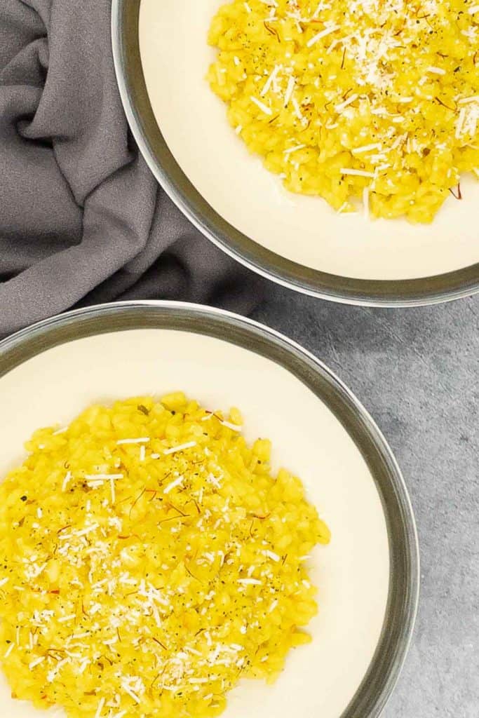 Homemade risotto zafferano with finely grated cheese.