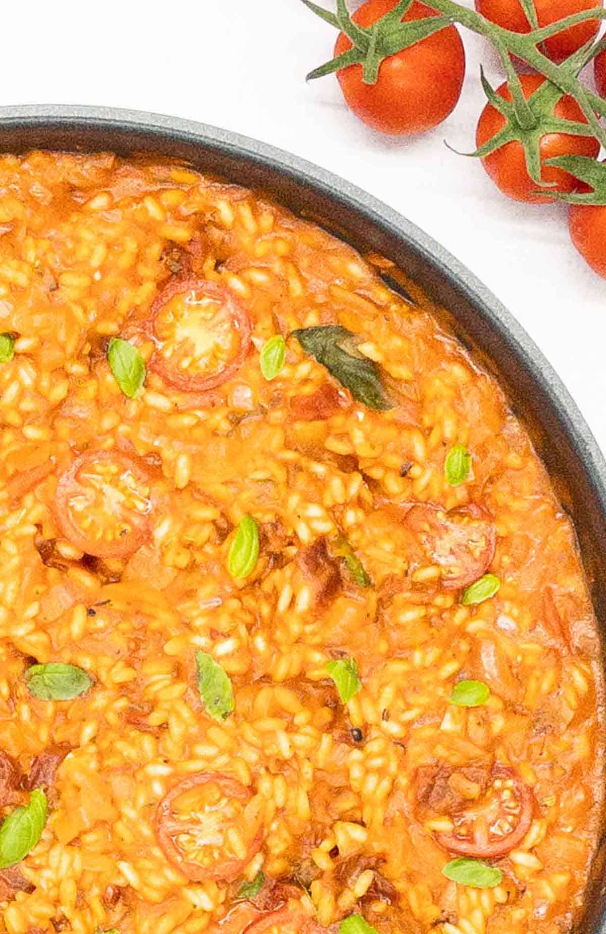 Delicious vegan risotto with tomatoes and vegan parmesan cheese.