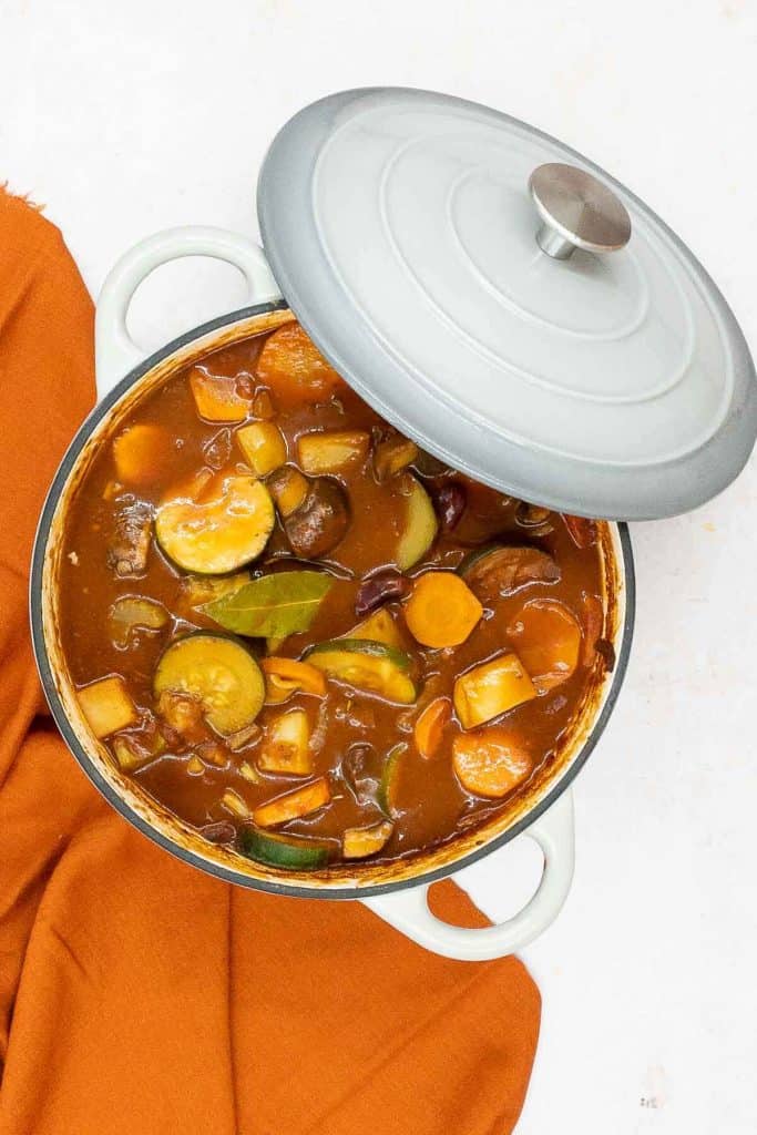 A Dutch oven of delicious homemade hearty vegetable stew cooked and ready to eat.