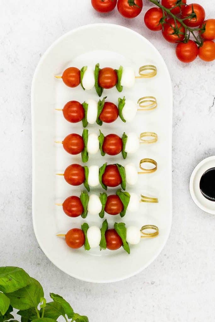 An overhead shot of Caprese skewers appetizer being made.