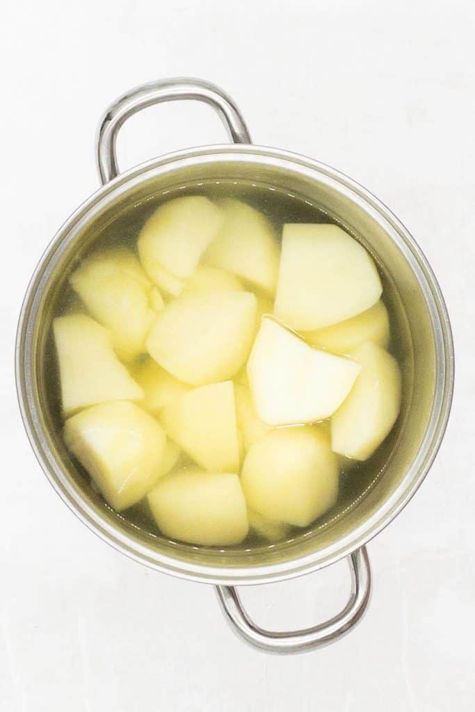 In a pan of salted water bring the potatoes to a boil and simmer.