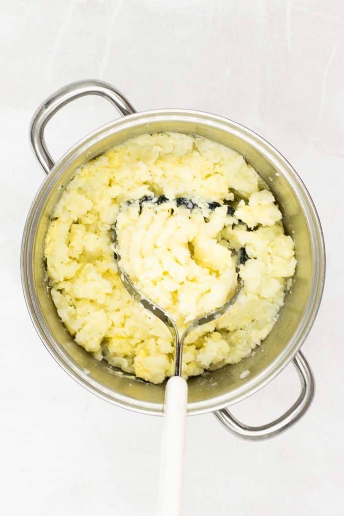 Mash the potatoes and ingredients.