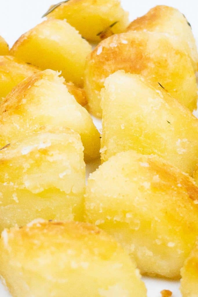 Close up of freshly made golden brown, crispy oven roasted potatoes.