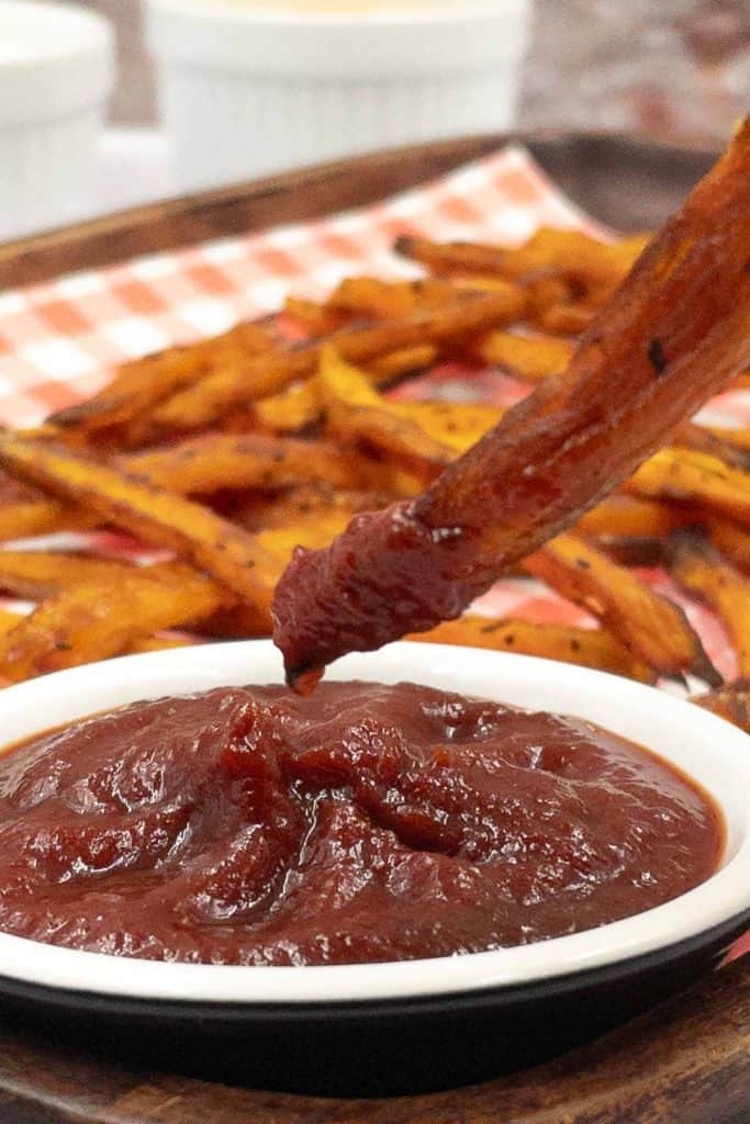 Dipping home made sweet potato fries into ketchup.