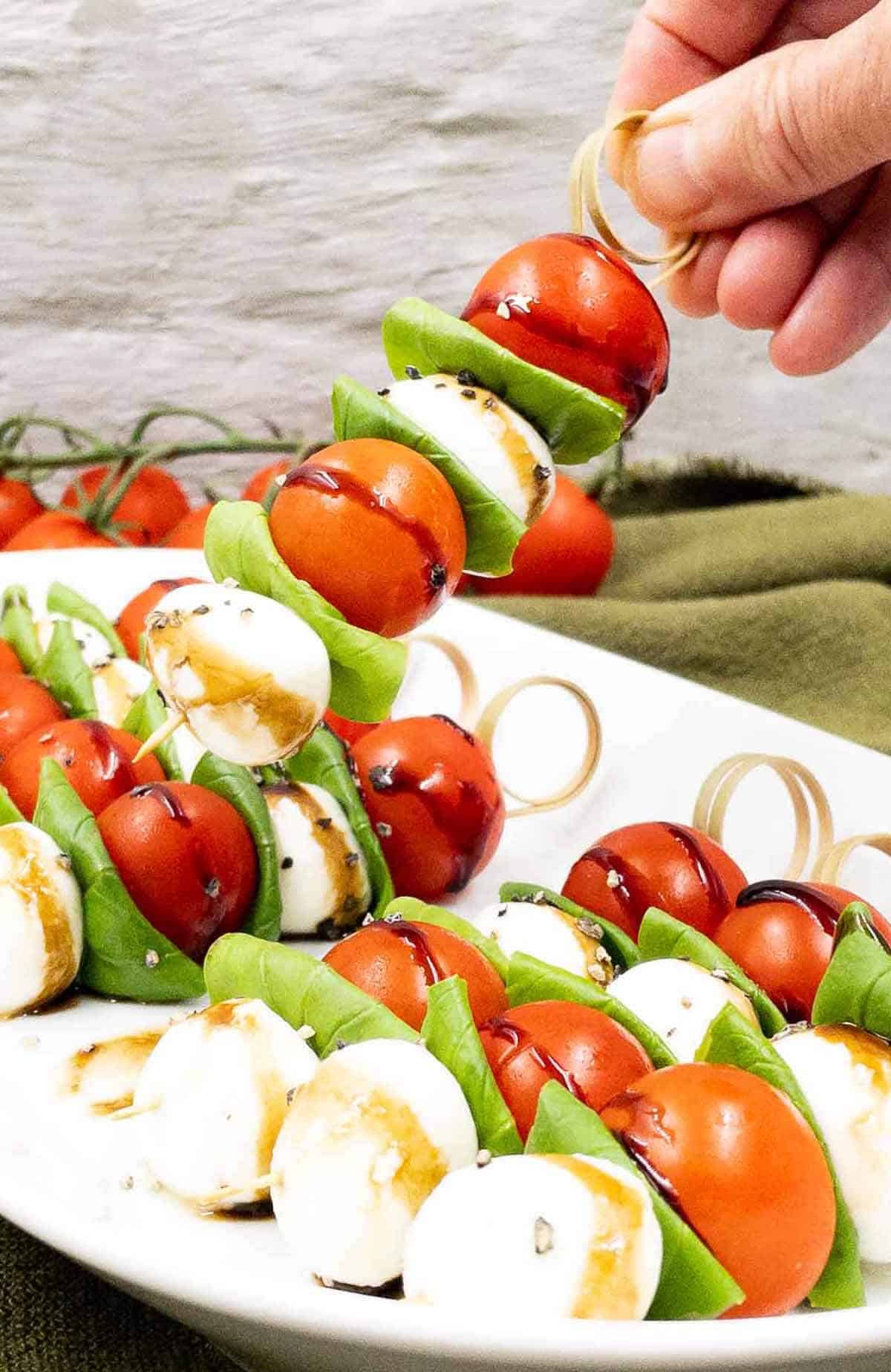 Caprese skewers appetizer on a serving plate.