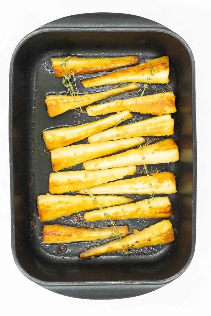Roast parsnips in roasting tin, golden brown and ready to eat.