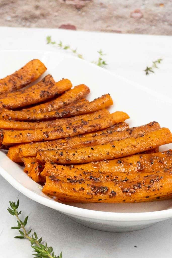 A serving plate with roast carrots made from scratch.