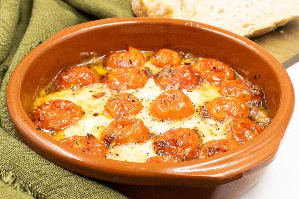A delicious bowl of tomato and baked goat's cheese, freshly made and ready to eat.