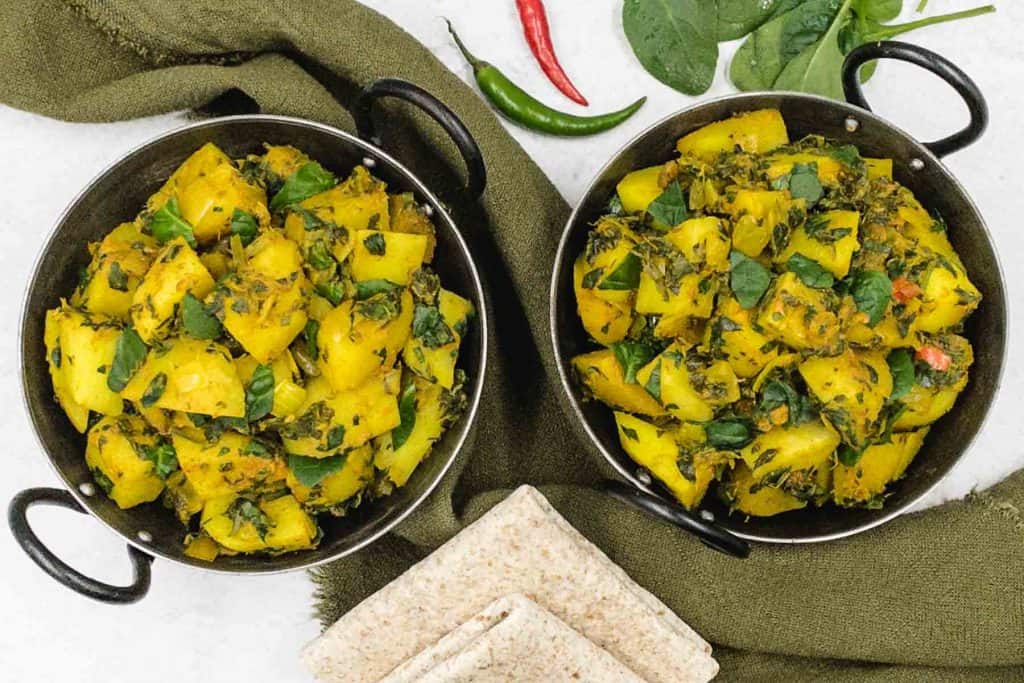 Two bowls of delicious spinach and potato curry.