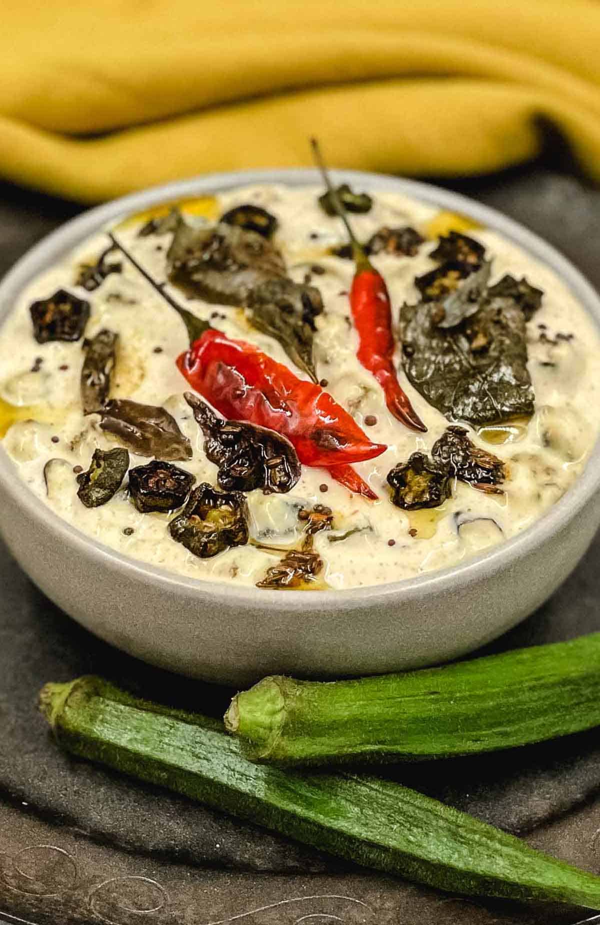 Homemade bhini raita with okra in the foreground.