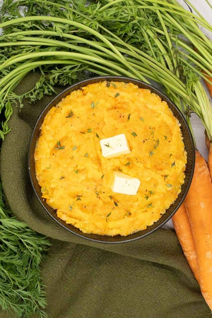 Homemade side dish of creamy carrot and swede mash.