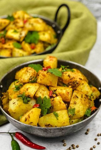 Tasty bowl of jeera aloo Indian side dish of cumin potatoes.