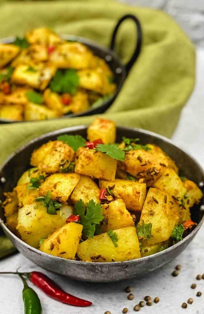 Tasty bowl of jeera aloo Indian side dish of cumin potatoes.