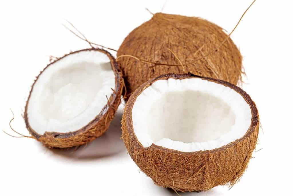 Two coconuts, one split in half.