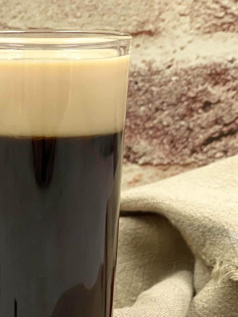 A close up of the head of a Guinness shot.