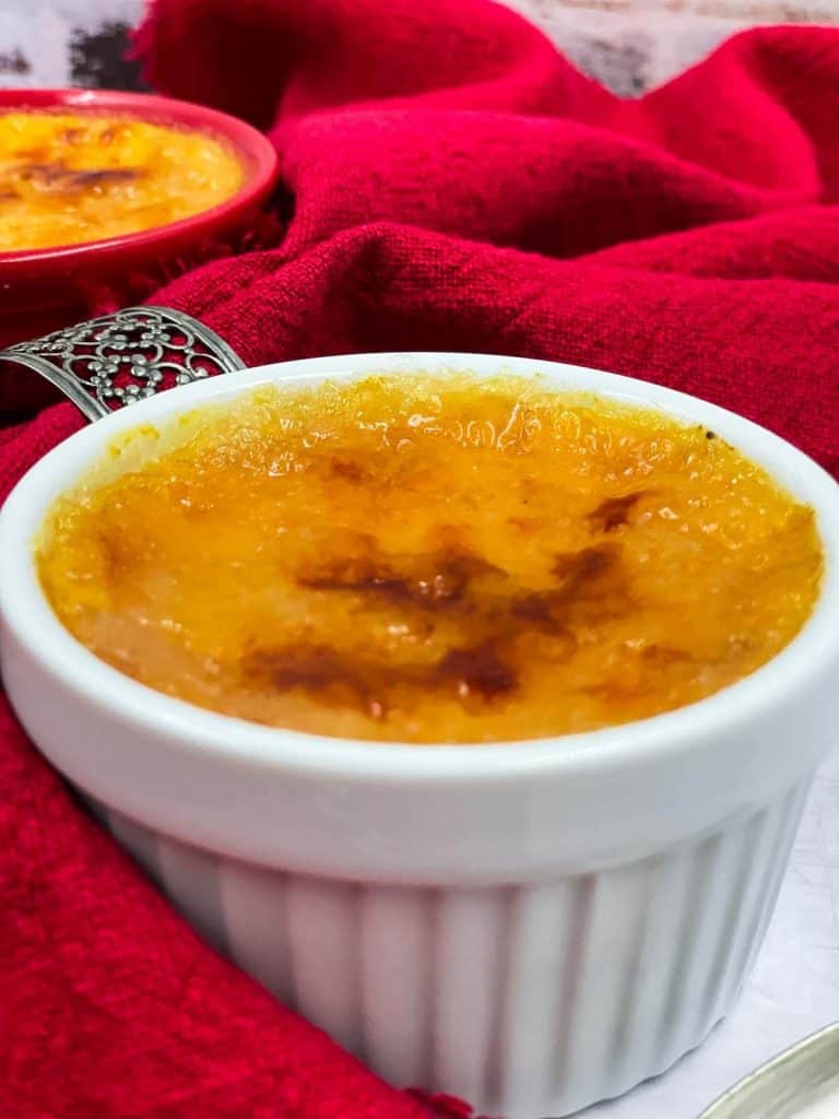 Tow perfect creme brulees with a golden brown sugar top.