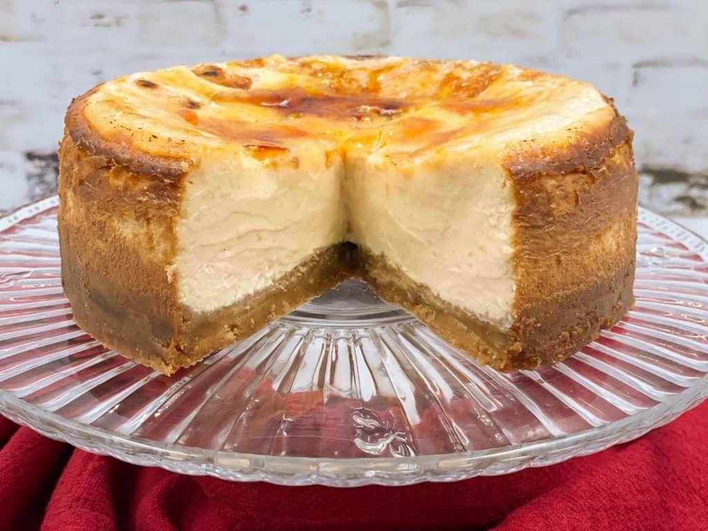 A cheesecake with a slice taken from it.