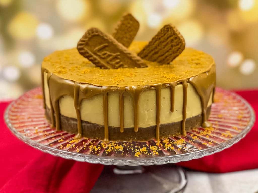 A delicious homemade Vegan Biscoff cheesecake on a cake stand.