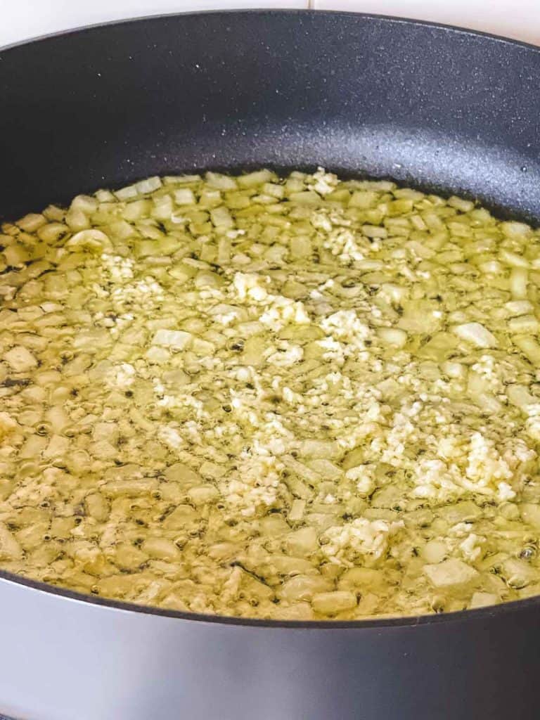 Add extra virgin olive oil, saute onions, add minced garlic.